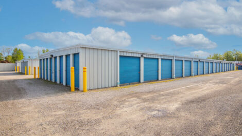 Graveled lot with Outdoor storage units.