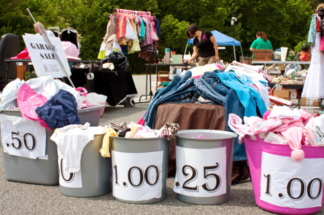 Garage sale bins with price signs.