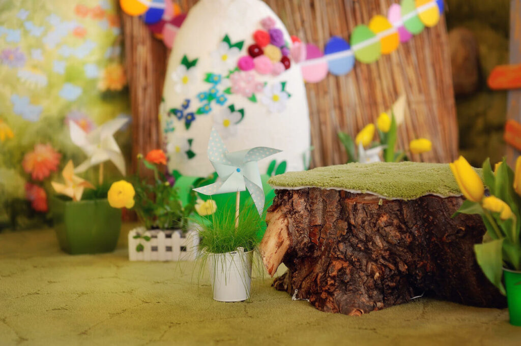 A room decorated with flowers, plants, and a tree stump