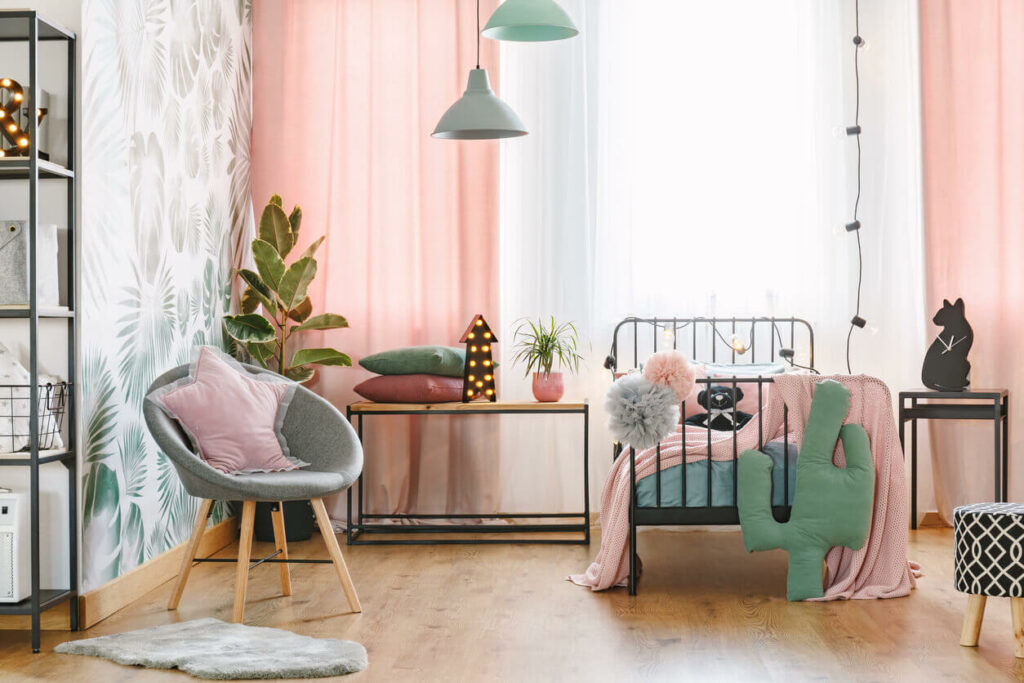 Large bedroom with pink, green, and gray furniture and decor.