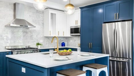 Organized kitchen with blue cabinets and white countertops.